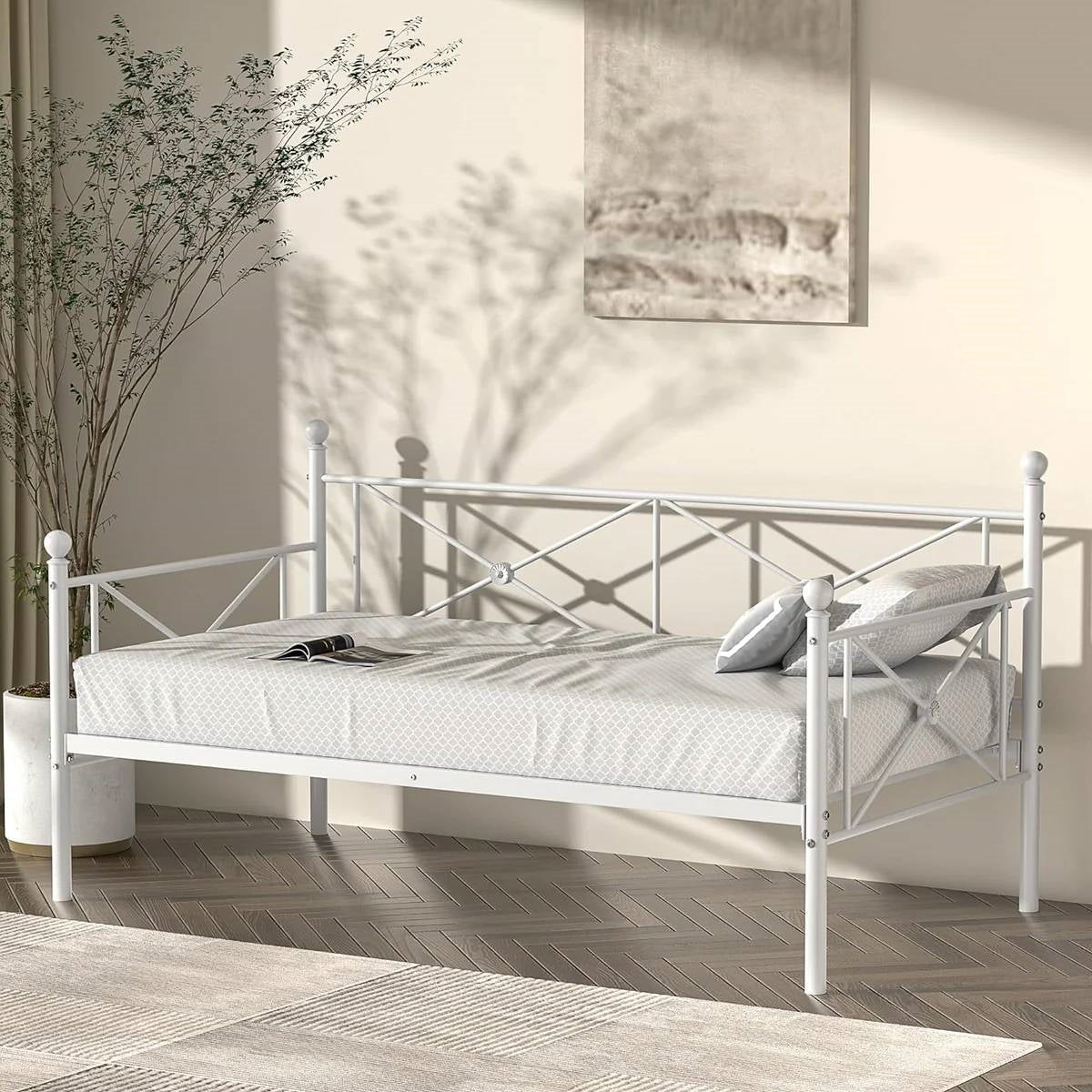 Twin size Heavy Duty Metal Daybed Frame in Classic White Finish against beige wall