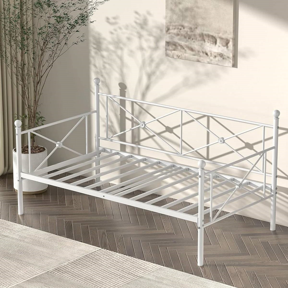 Twin size Heavy Duty Metal Daybed Frame in Classic White Finish displayed in a sunlit room.