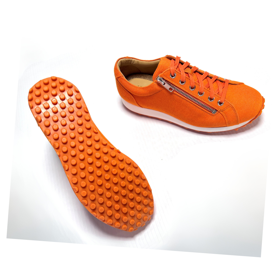 WesTees Lienza Zinnia eco-friendly orange golf and walking shoe with recycled fabric and impact-absorbing sole.