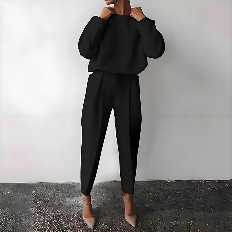 Woman wearing Women’s Solid Color 2-Piece Set – Long Sleeve Top & Pleated Pants Loungewear in black.