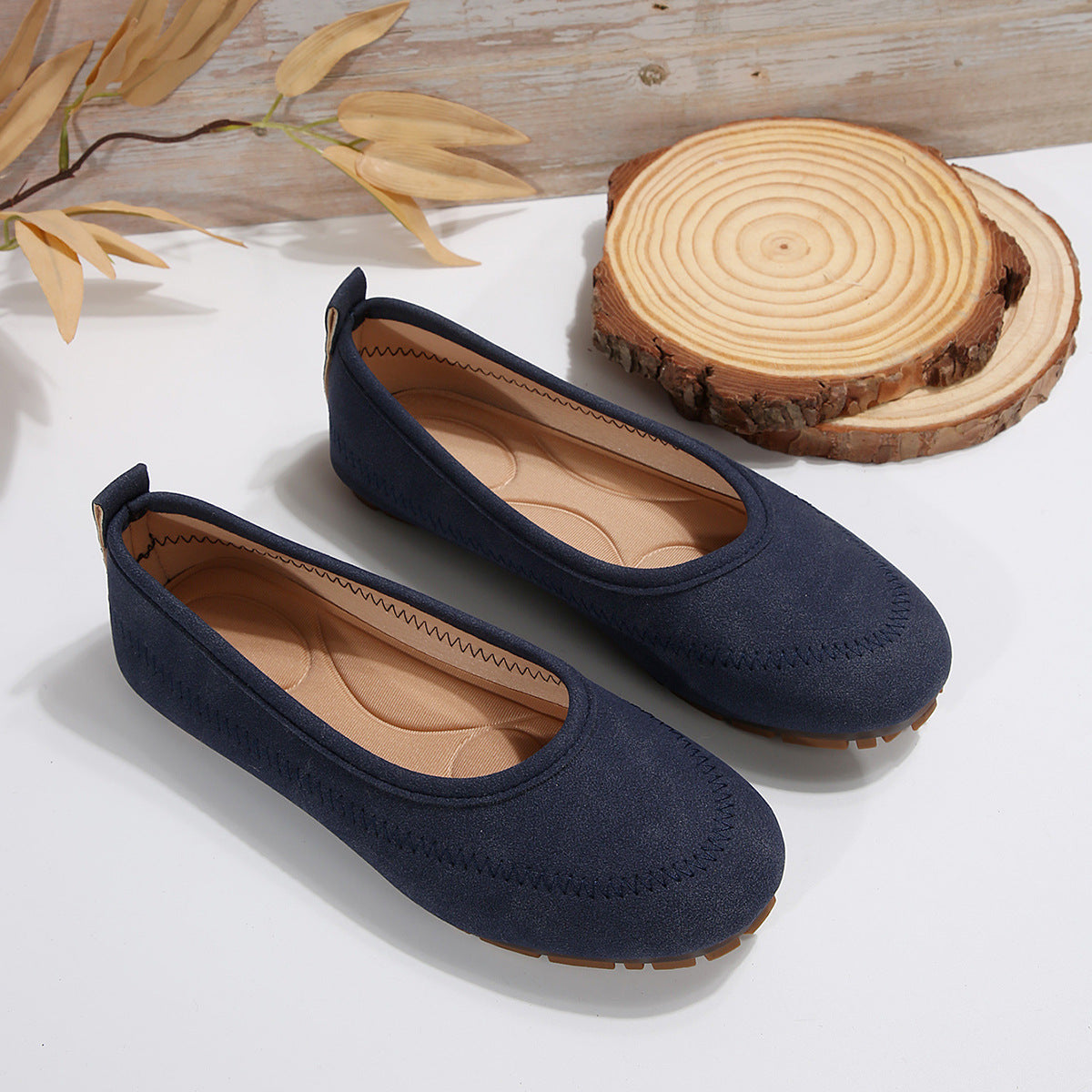 Women’s Low-Cut Round Toe Loafers – Slip-On Flat Casual Shoes in navy color, displayed on a white surface with wooden decor.