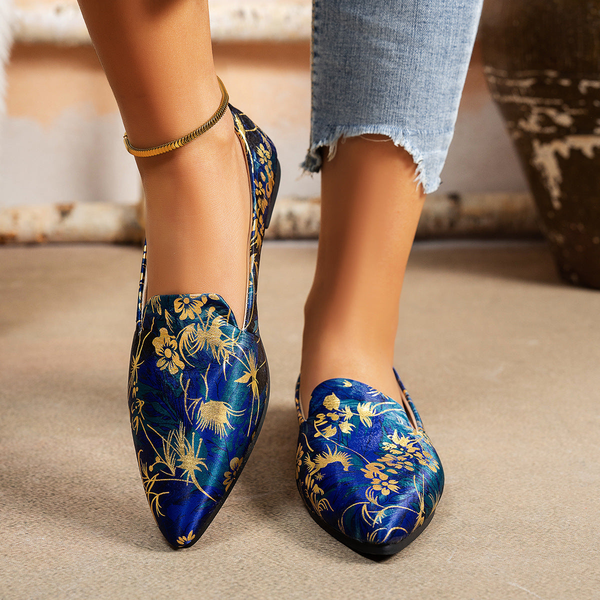 Women's Flat Pointed-Toe Thin Shoes — Casual Everyday Flats in blue floral pattern worn by a model with distressed jeans.