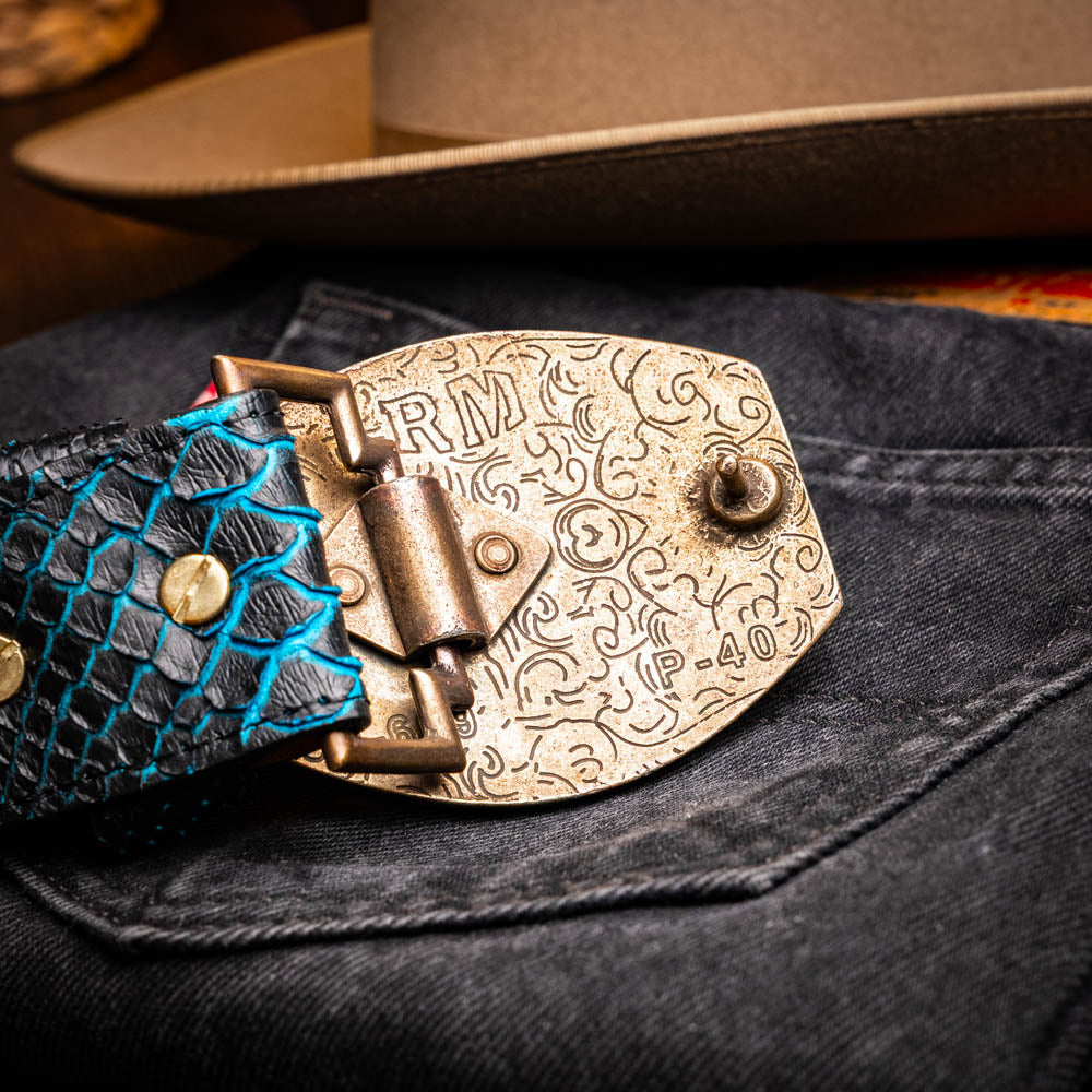 Arkansas Belt Black / Blue with genuine python skin and antique brass buckle on denim, showcasing Western style craftsmanship.