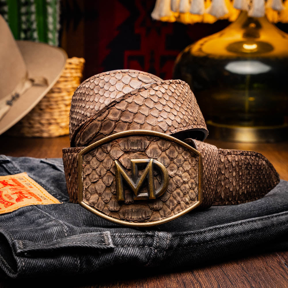Arkansas Belt Brown with genuine python skin and antique brass buckle on denim background