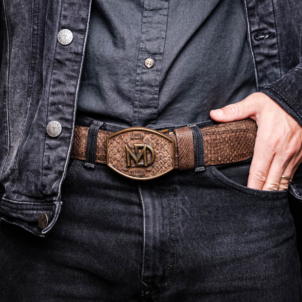 Arkansas Belt Brown made from genuine python skin with antique brass buckle, showcasing Western style on black outfit.