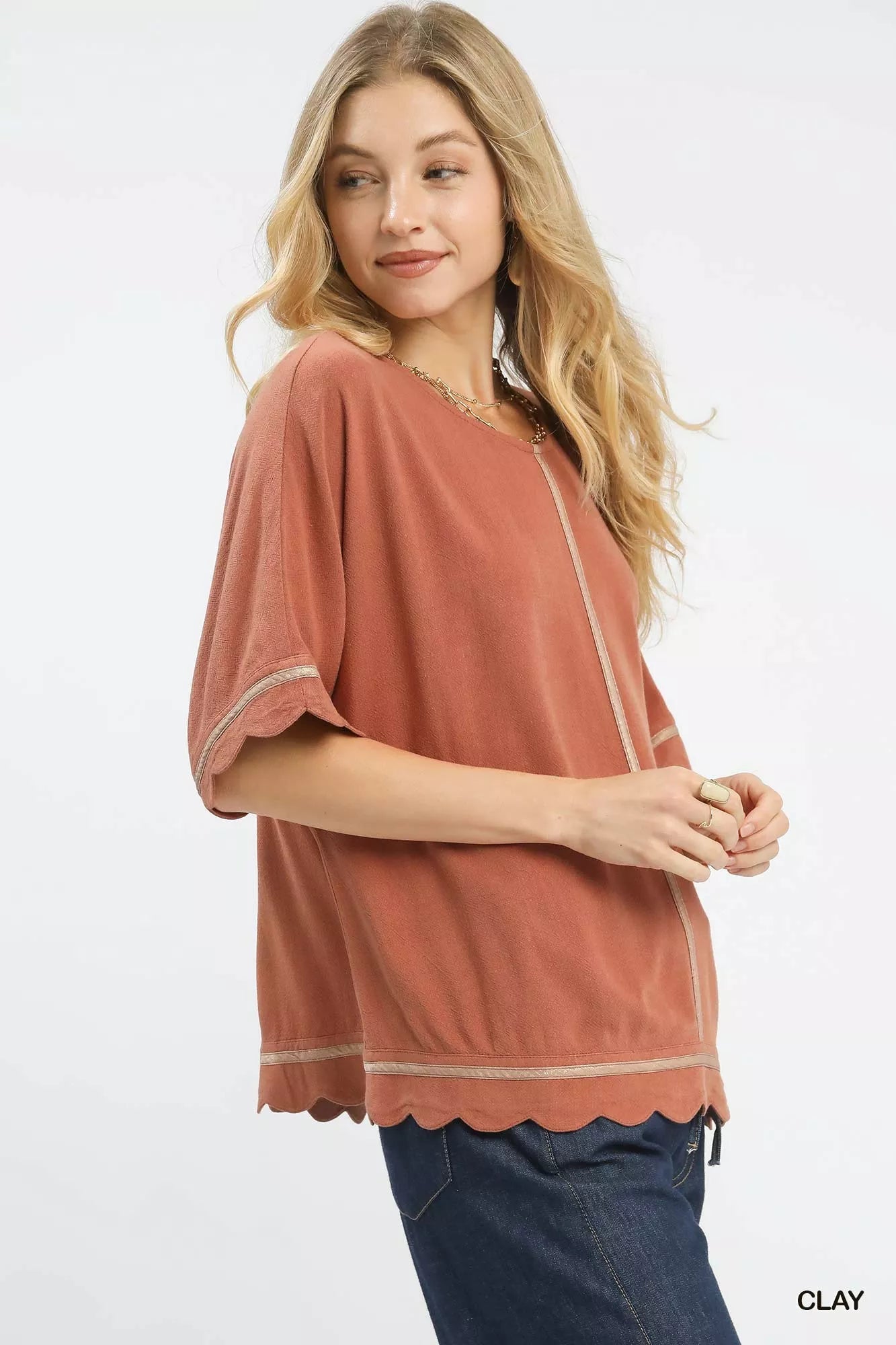 Woman wearing Umgee Linen Blend Scallop Trim Top in clay color