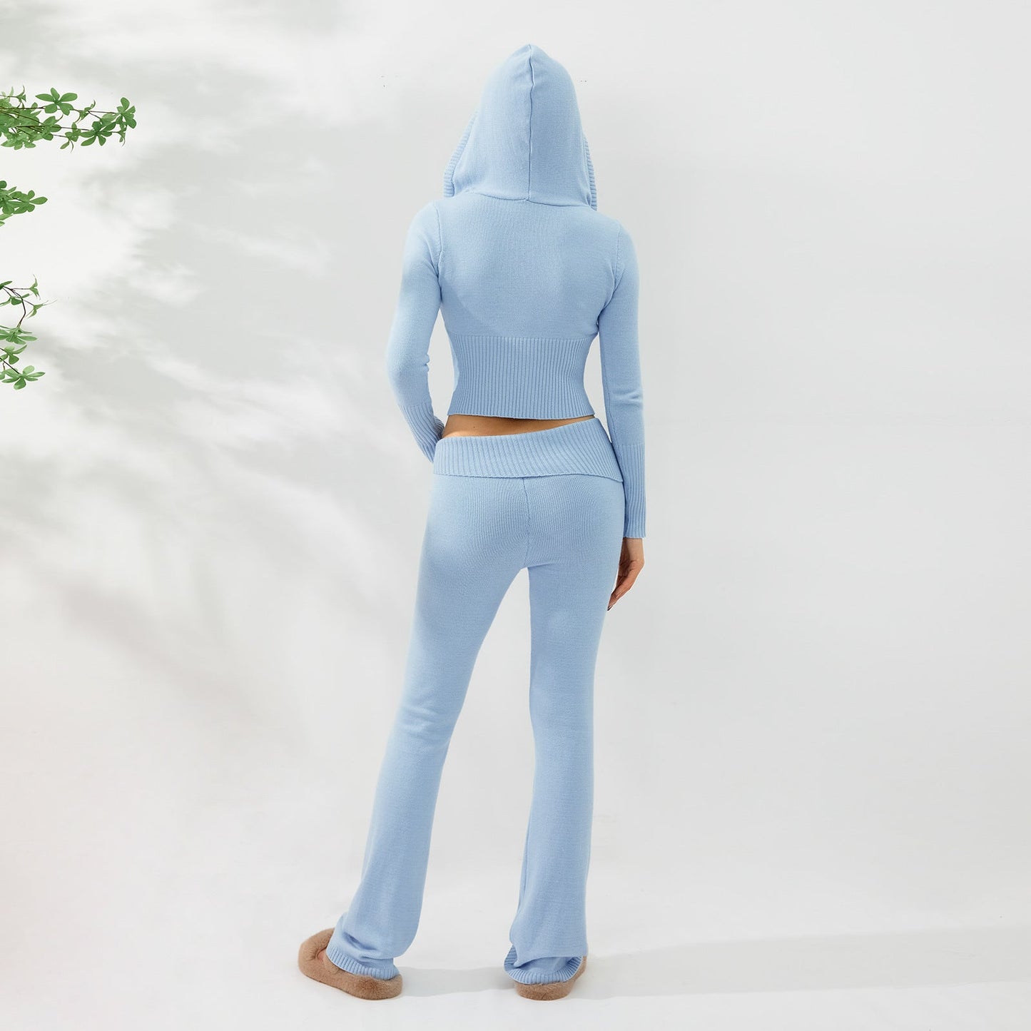 Woman wearing light blue Women’s Knitted Hooded Two-Piece Set – Cardigan & High-Waisted Pants Suit, viewed from the back.