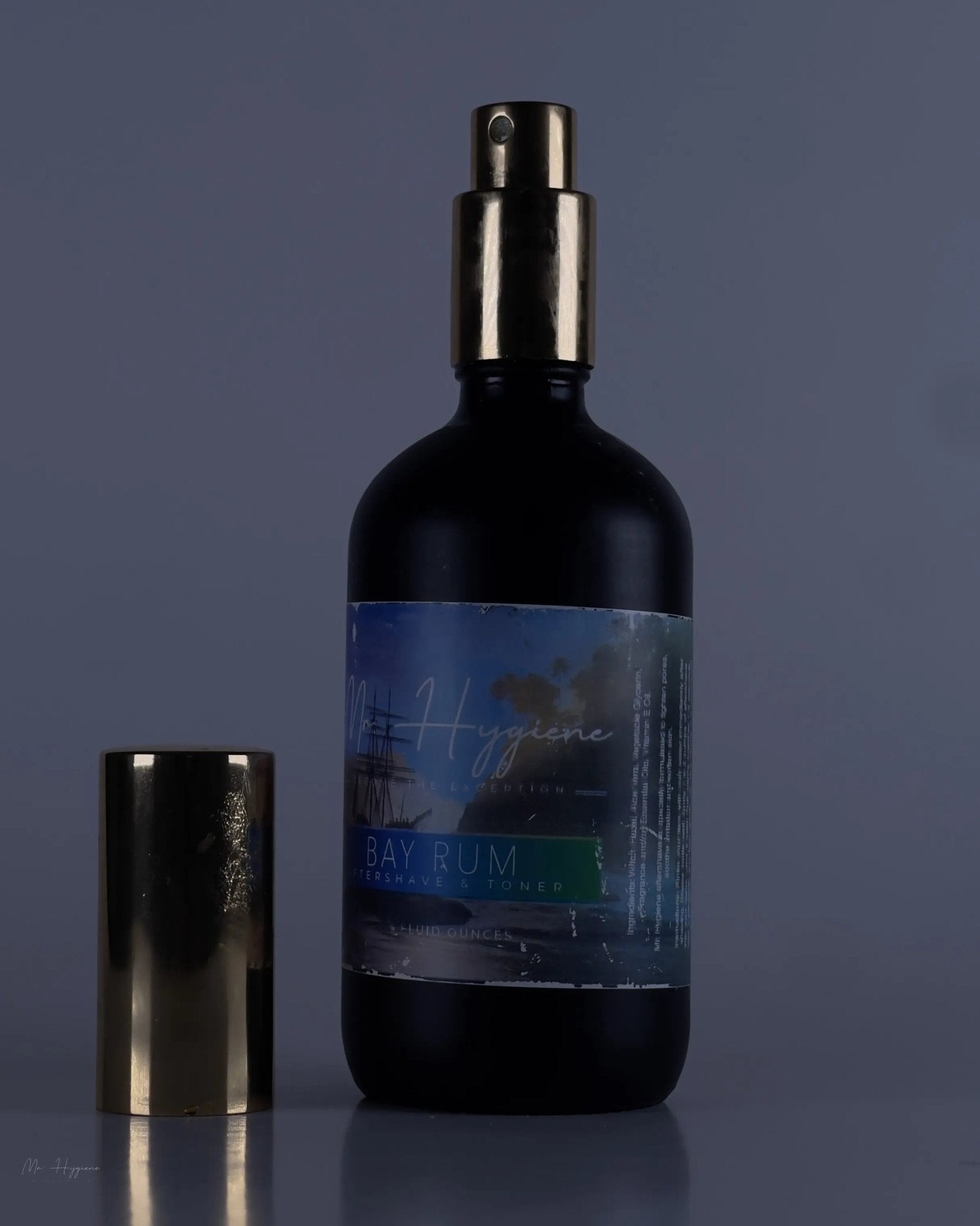 Bay Rum Aftershave bottle with golden cap, nourishing men's skincare product for hydration and soothing, non-alcohol based formula.