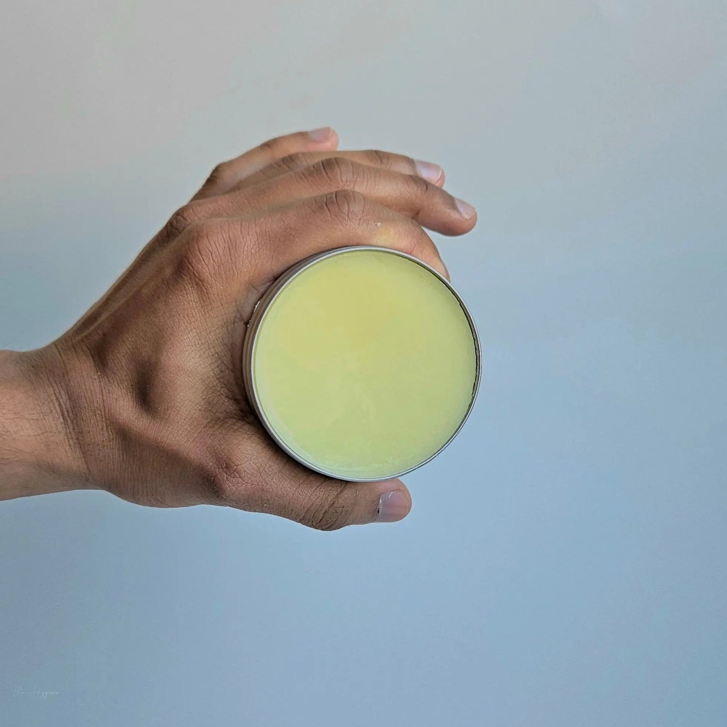 Hand holding Bay Rum Beard Balm – Bold Scent & Daily Control