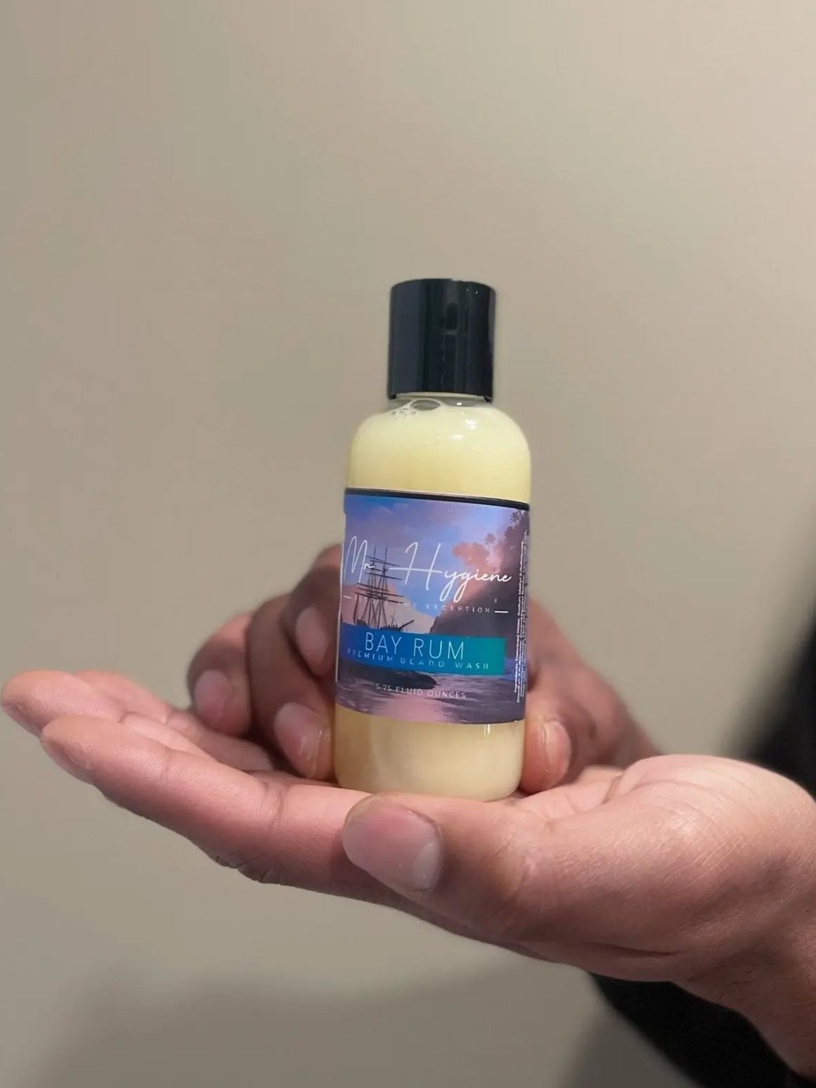 Hand holding Bay Rum Beard Wash – Bold Scent, Clean Beard Routine bottle.