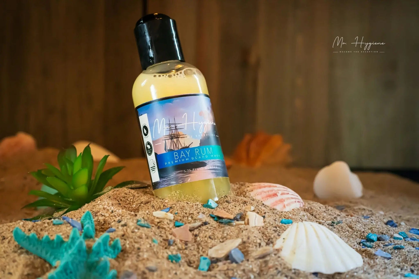 Bay Rum Beard Wash – Bold Scent, Clean Beard Routine bottle on sandy beach with seashells and green plant