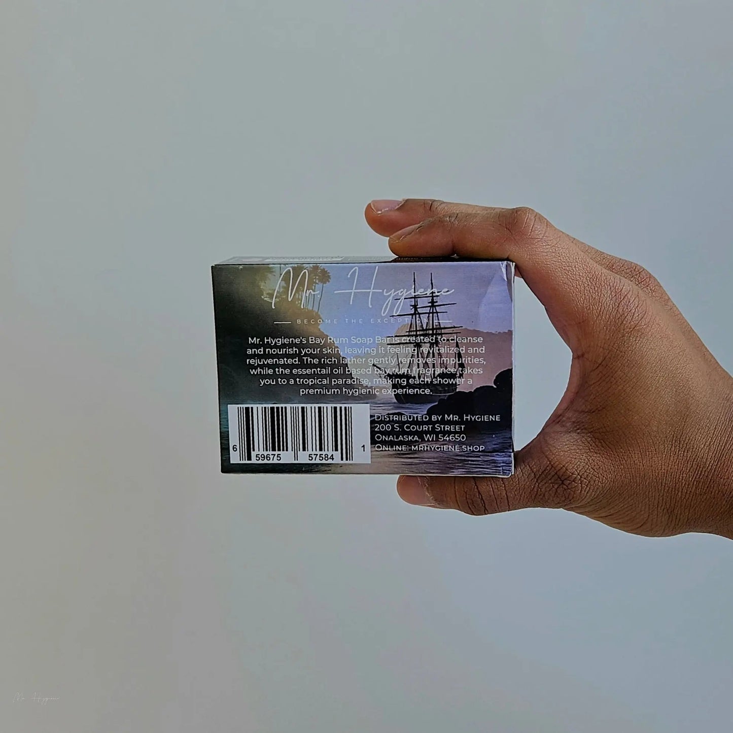 Hand holding a box of Bay Rum Mens Soap – Classic Scent, Modern Clean with a ship illustration and product details.