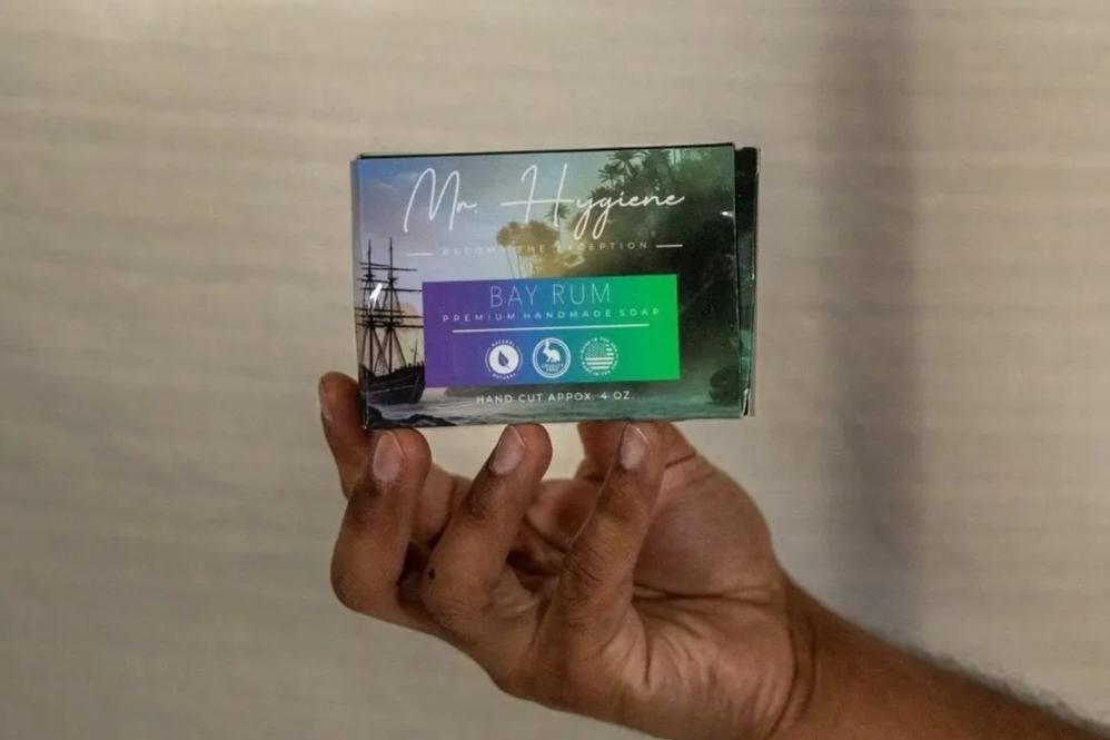Hand holding Bay Rum Mens Soap – Classic Scent, Modern Clean, with rich aroma packaging for refreshing skincare.