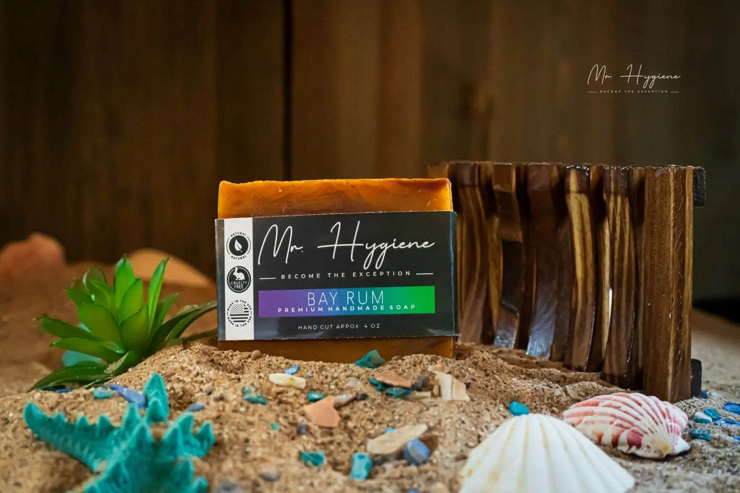 Bay Rum Mens Soap – Classic Scent, Modern Clean bar displayed on sandy surface with seashells and wooden soap holder.