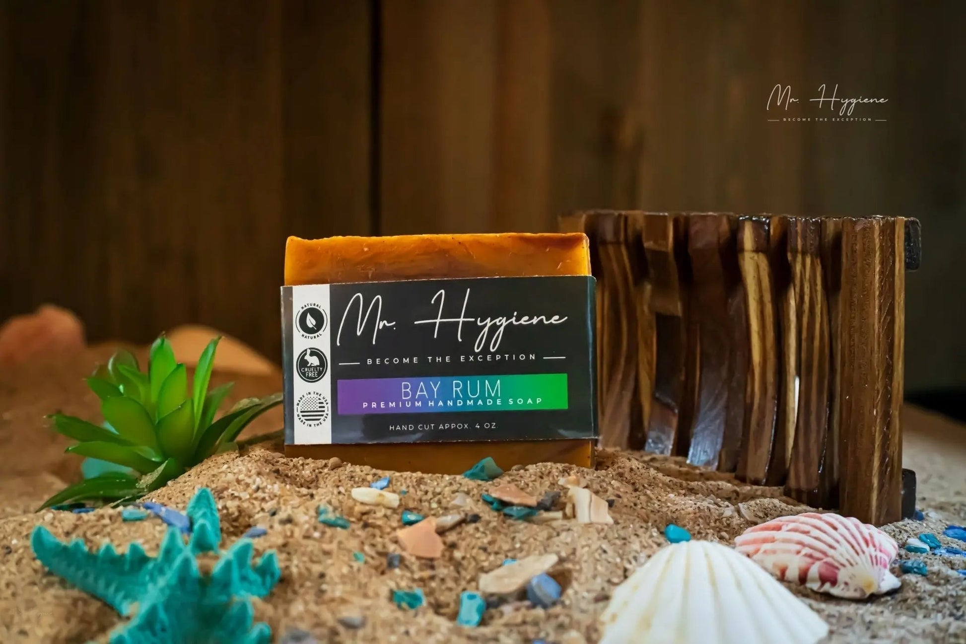 Bay Rum Mens Soap – Classic Scent, Modern Clean bar displayed on sandy surface with seashells and wooden soap holder.
