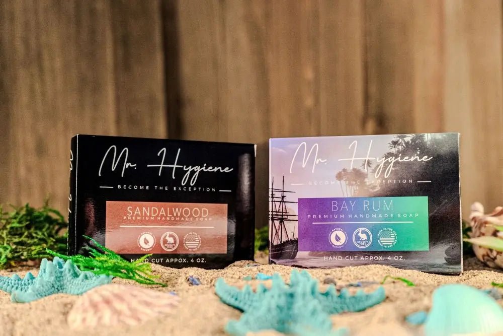 Bay Rum & Sandalwood Bar Soaps displayed on beach sand with decorative seashells.