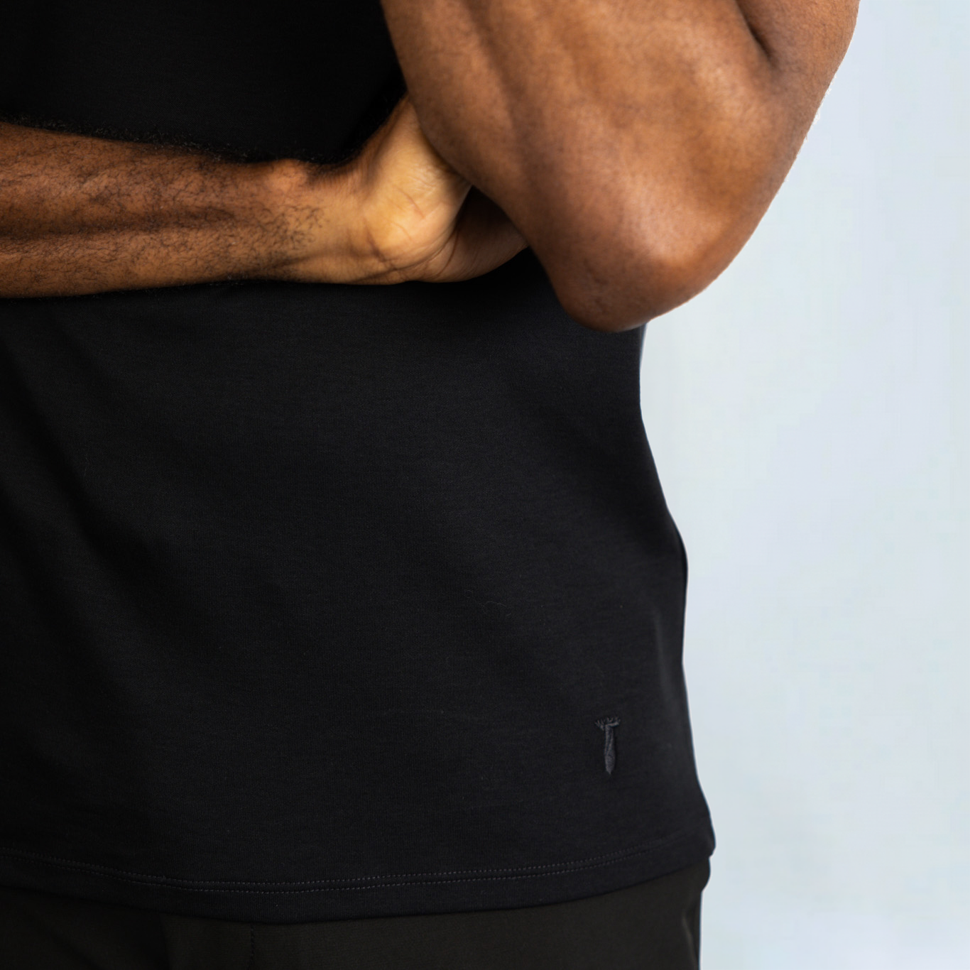 Man wearing black Short Sleeve Perfect Tee made from Peruvian Pima cotton, showcasing its wrinkle-resistant and moisture-wicking qualities.