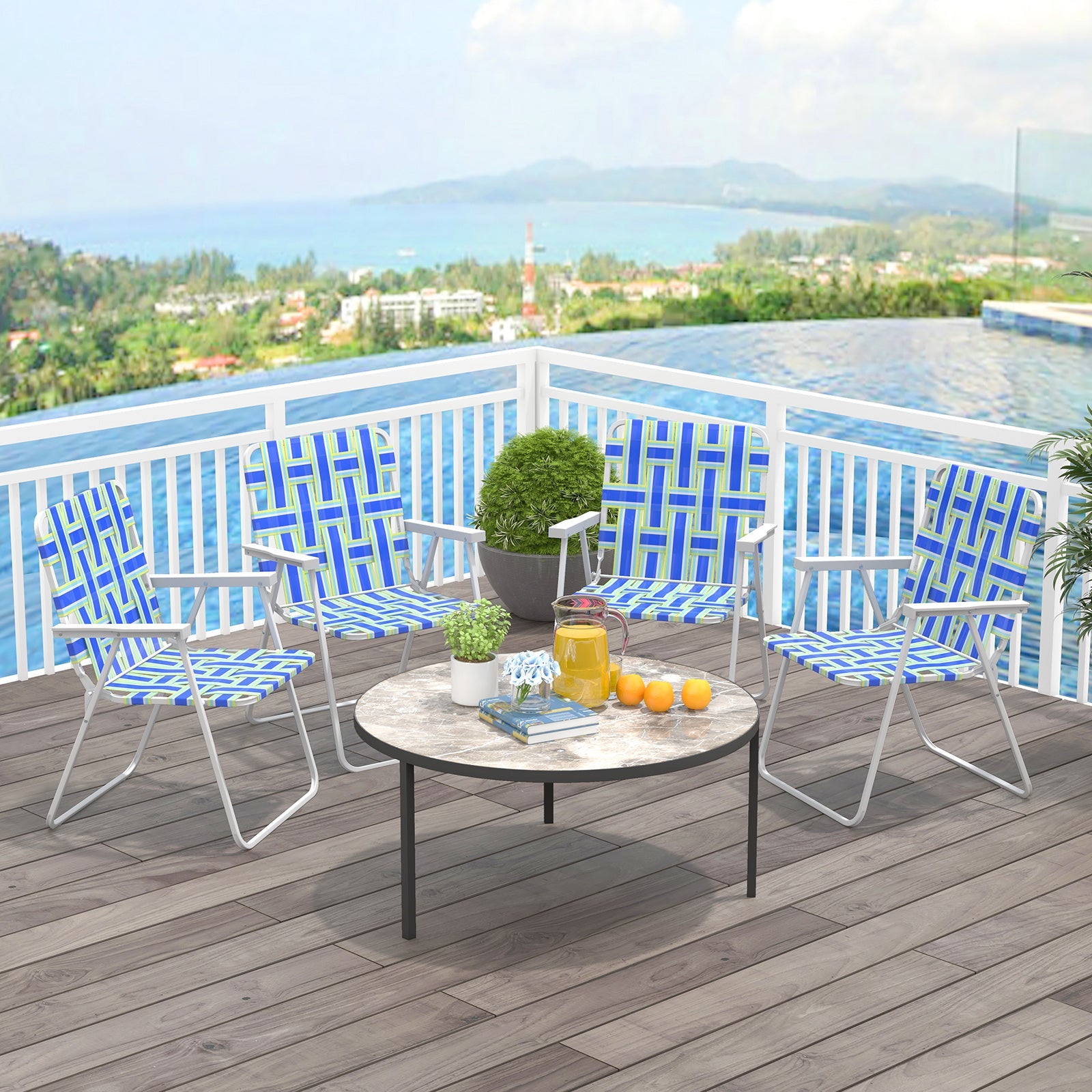 4 Pieces Folding Beach Chair Camping Lawn Webbing Chair-Blue on a patio with a table overlooking a scenic view