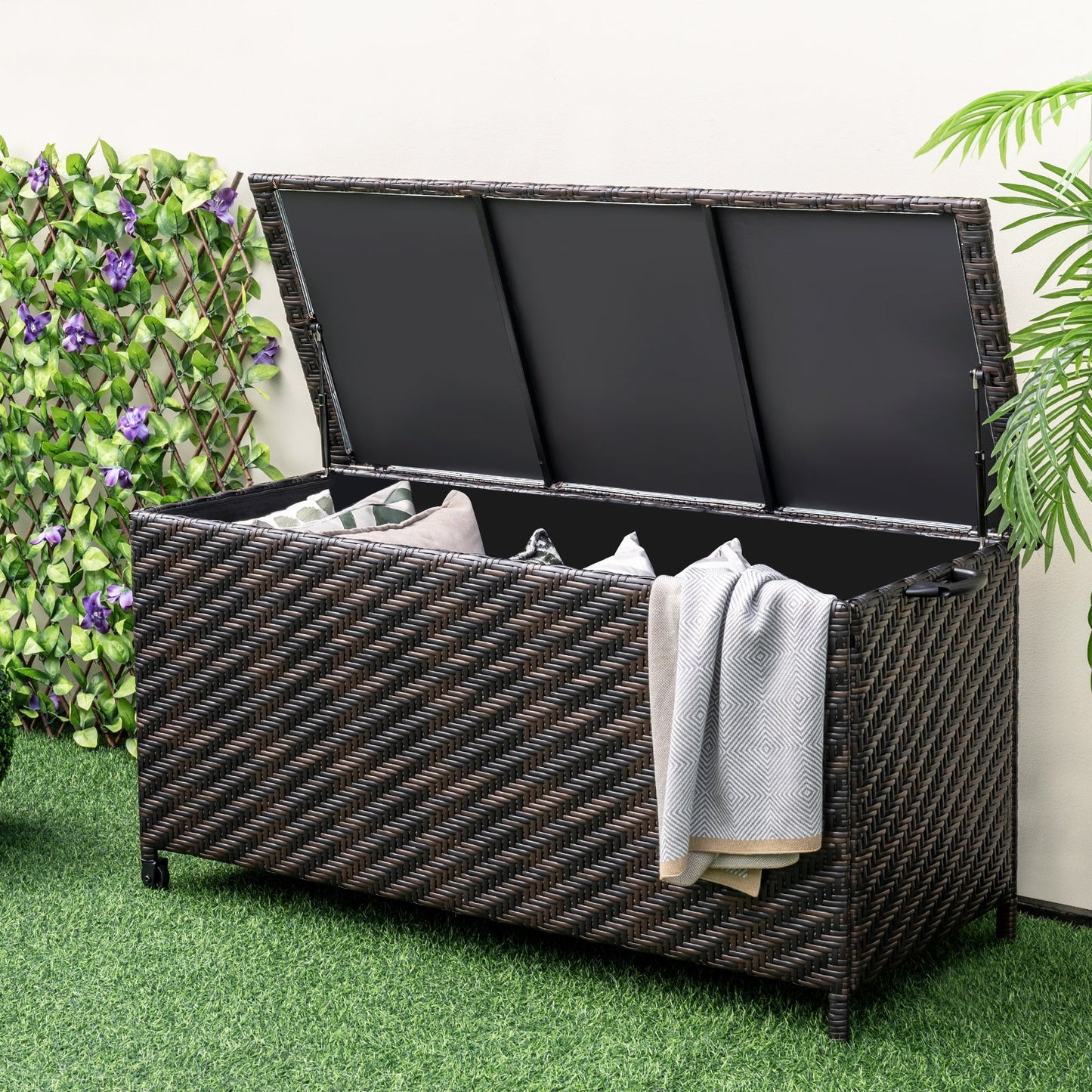 85 Gallon Outdoor Storage Box with Removable Liner and Universal Wheels-Brown in garden setting