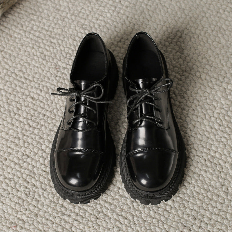 Women’s Solid-Color Retro Slip-On Platform Shoes in black on carpet