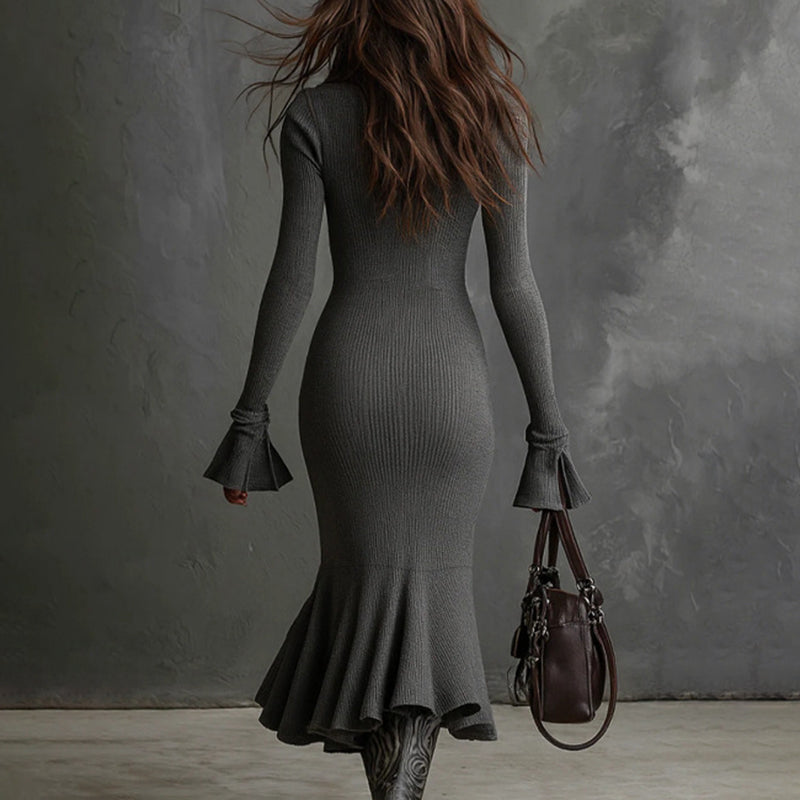 Rear view of a woman wearing Women's Half Zip Bodycon Dress with flared sleeves and fishtail hem, holding a handbag.