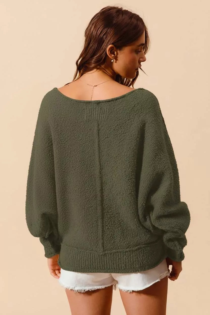 Woman wearing SO ME Loose Fit Exposed Seam Slouchy Boucle Sweater in green, showcasing a relaxed and stylish look for cozy days.