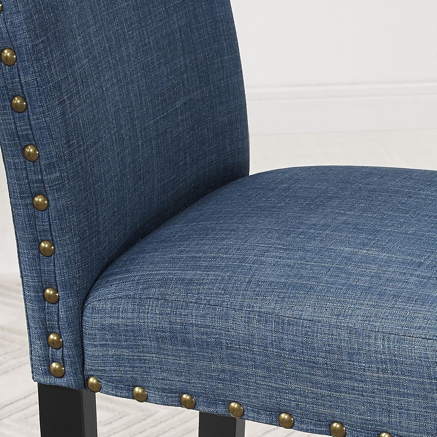 Close-up of blue upholstered chair with brass nailhead trim, part of the Espresso Wood Counter Height Dining Set.