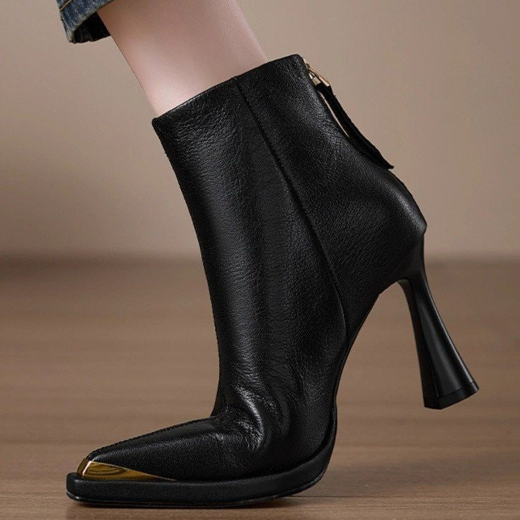 Black Women’s Pointed-Toe Chunky-Heel Side-Zip Boots with sleek design on wooden floor