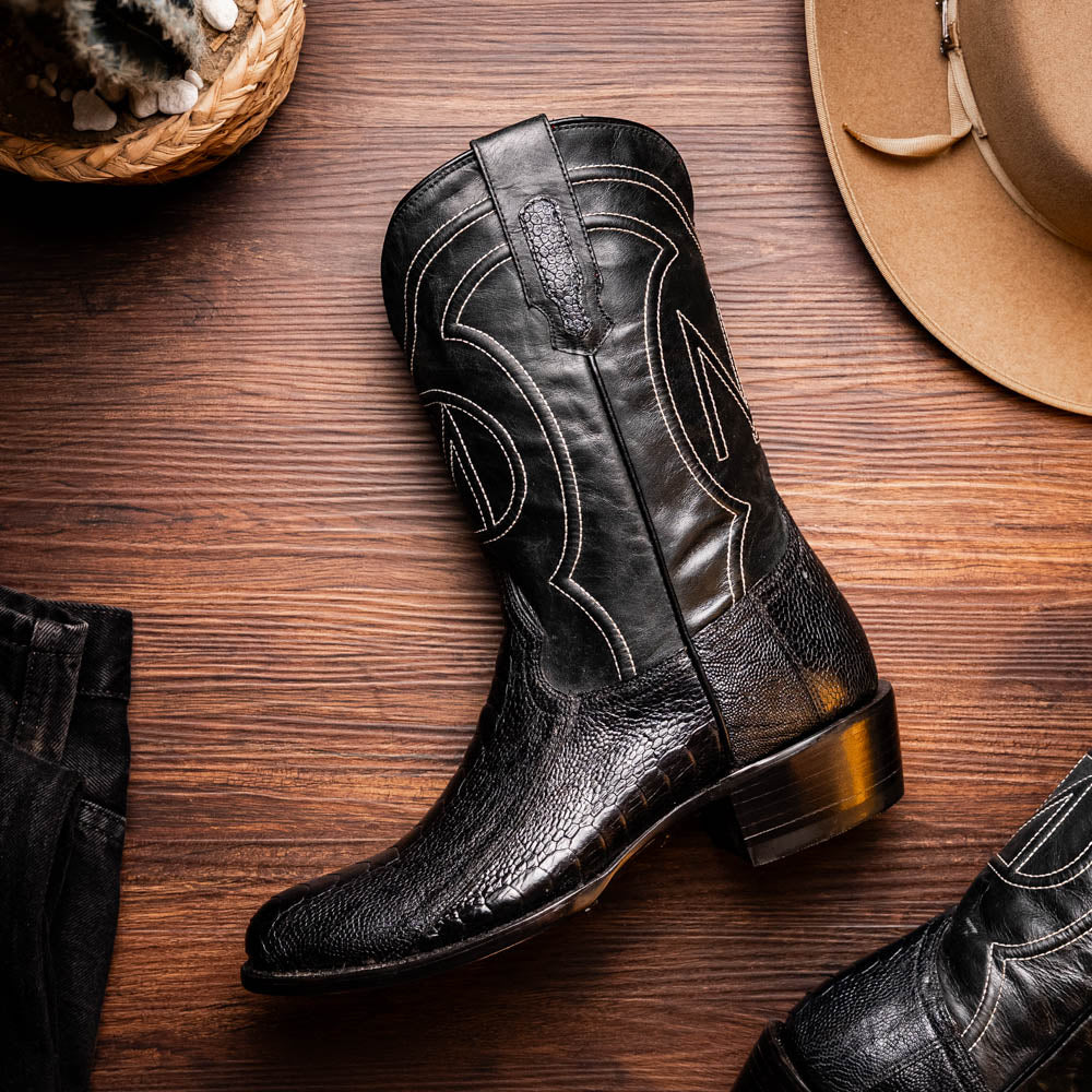 Denver Black cowboy boot made from genuine ostrich leg skin, showcasing luxury western style with intricate details and a red vamp.