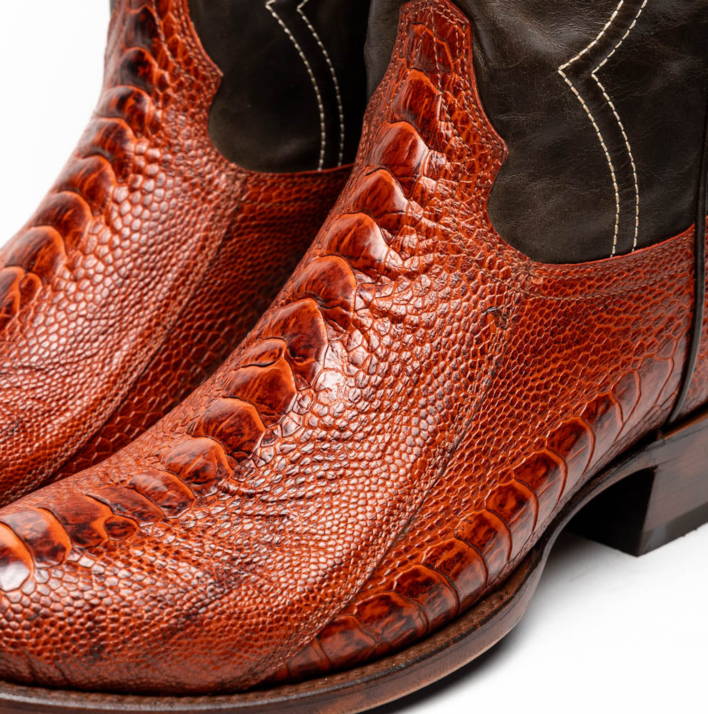 Close-up of Denver Rustic Cognac ostrich leg skin cowboy boots, showcasing detailed texture and rich red color.