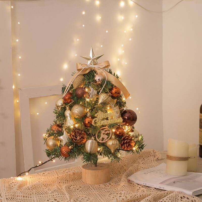 Tabletop Christmas Tree with snow flocking, gold ornaments, and lights, perfect for home or office holiday decor.