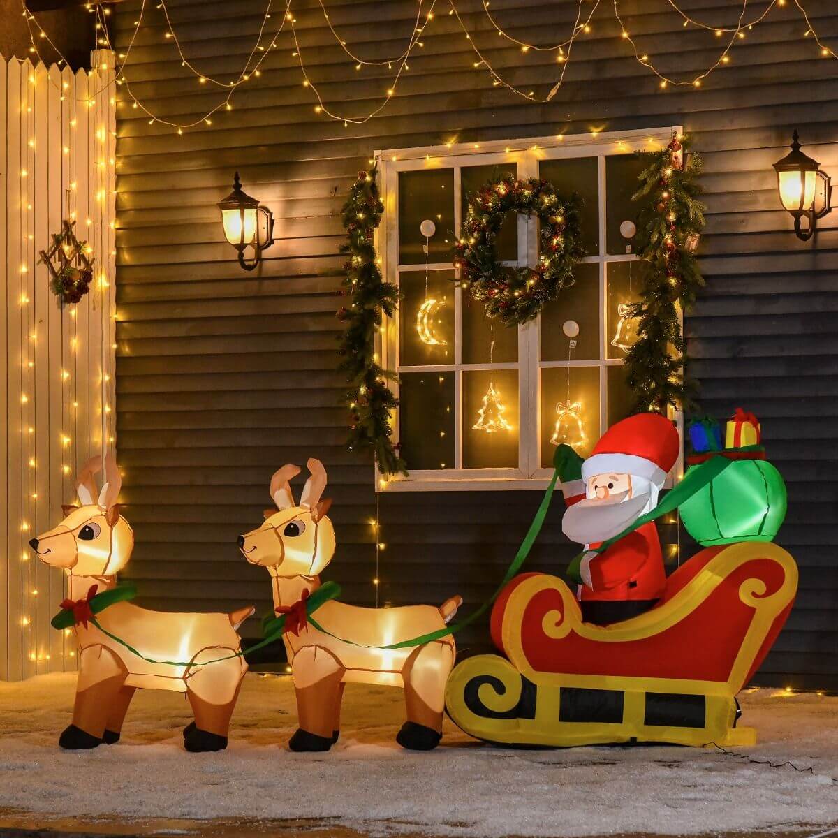 Christmas Inflatable Santa Claus with Sleigh decorated with festive lights and reindeer in a holiday yard display.
