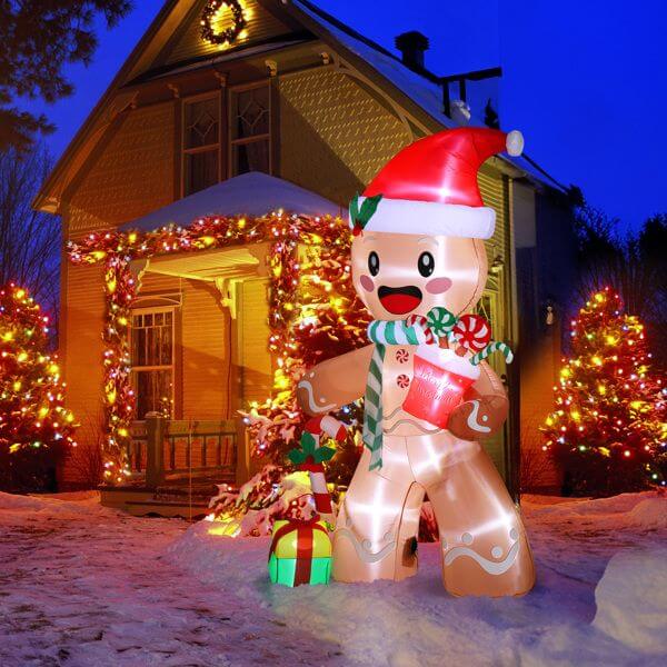 Christmas Inflatable Decoration - 7.9ft gingerbread man with LED lights in front of a festive house