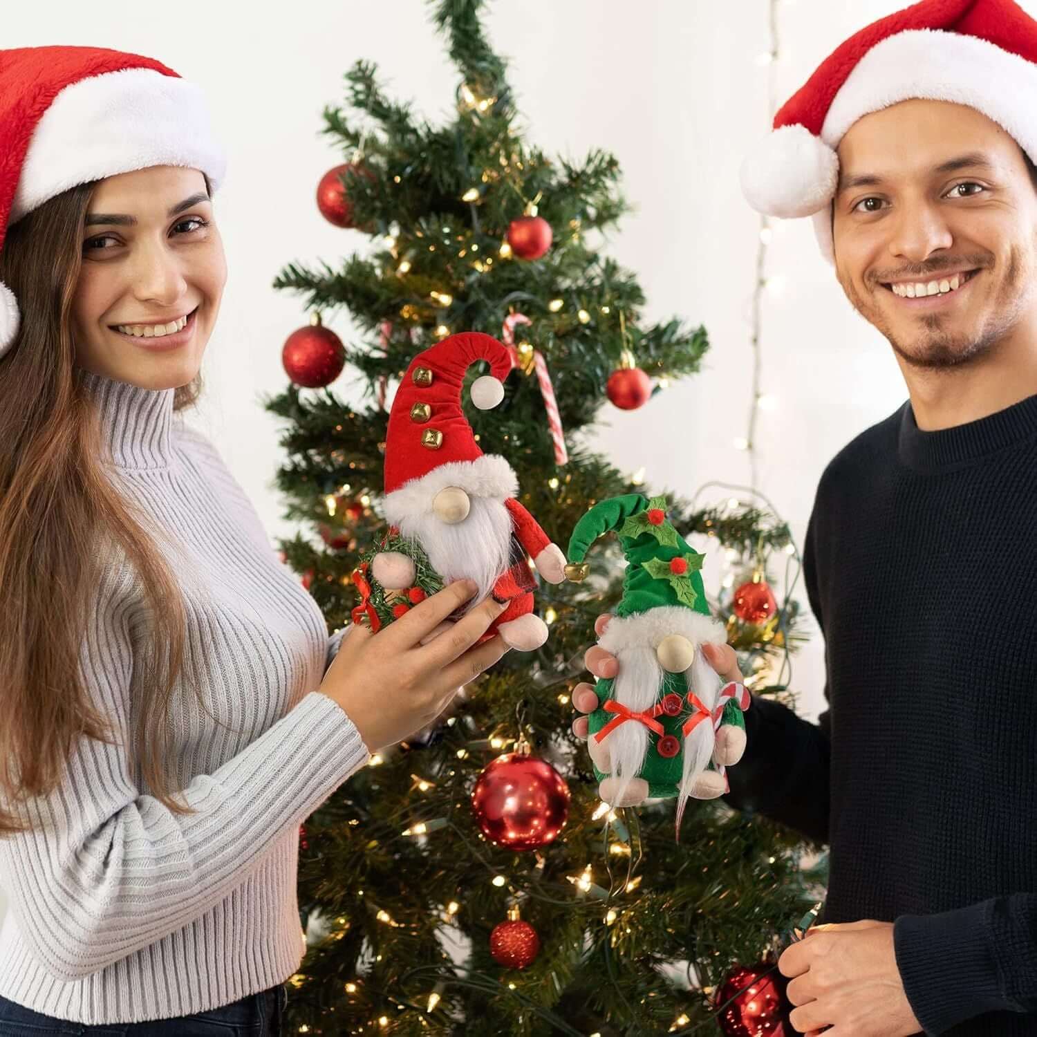Couple decorating a Christmas tree with Christmas Gnomes Plush, 2 pack Swedish gnome figurines, adding festive charm to their home.