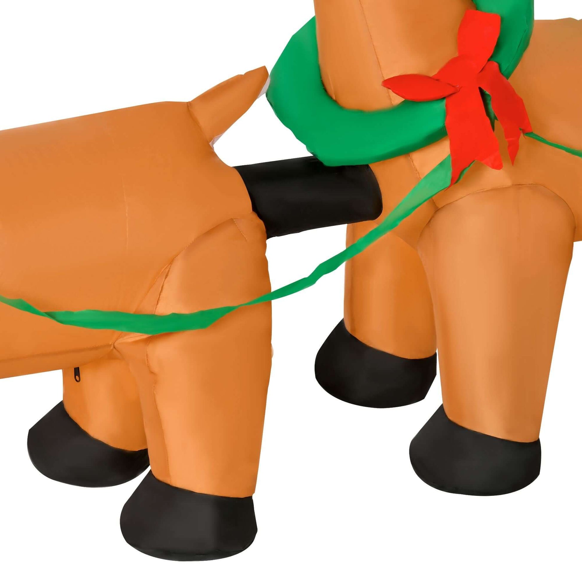 Close-up of Christmas Inflatable Santa Claus with Sleigh highlighting reindeer legs and festive decorations.