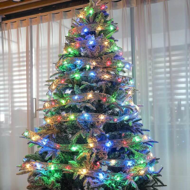 Christmas Glowing Ribbon Led Light String on a Christmas tree, featuring Bluetooth-controlled symphony lights in multicolor and gold.