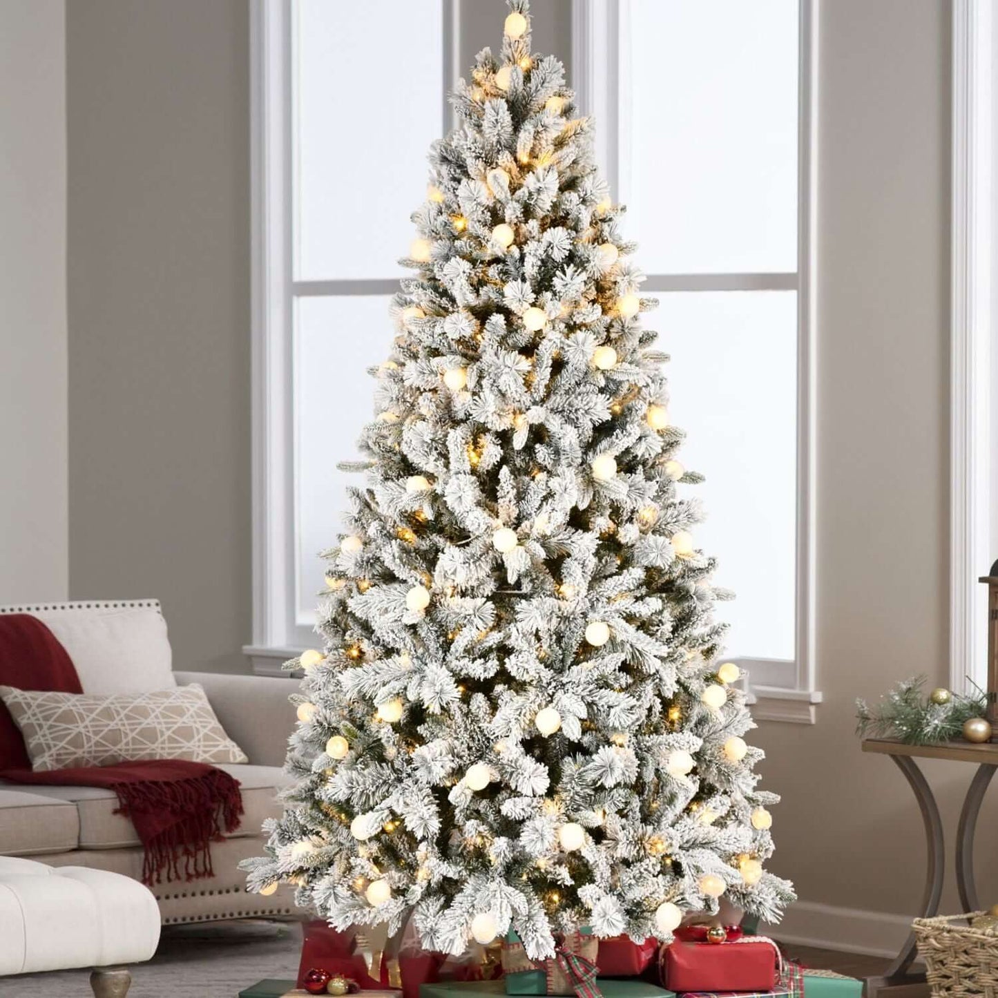 Alt Tag: Flocked Christmas Tree with Colorful Lights in a cozy living room, featuring snow-flocked branches and vibrant holiday decor.
