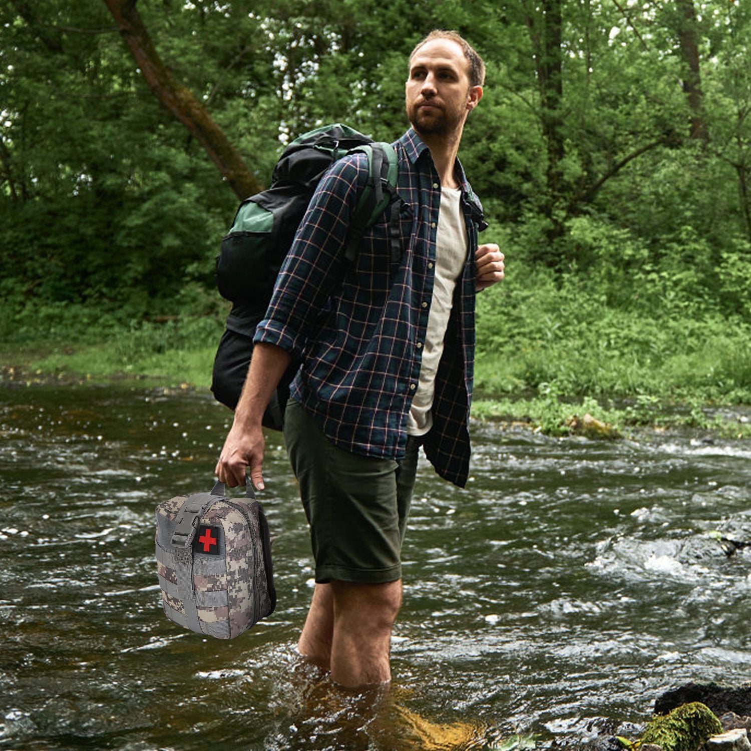 Man hiking through stream holding 125Pcs Survival Kit for outdoor adventure camping and wilderness first aid needs.