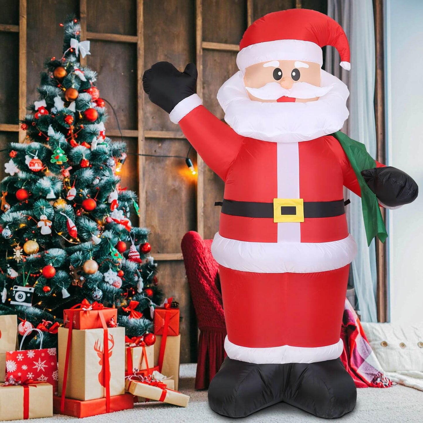6.4ft Inflatable Christmas Giant Santa Claus with a large green gift bag beside a decorated Christmas tree and presents.