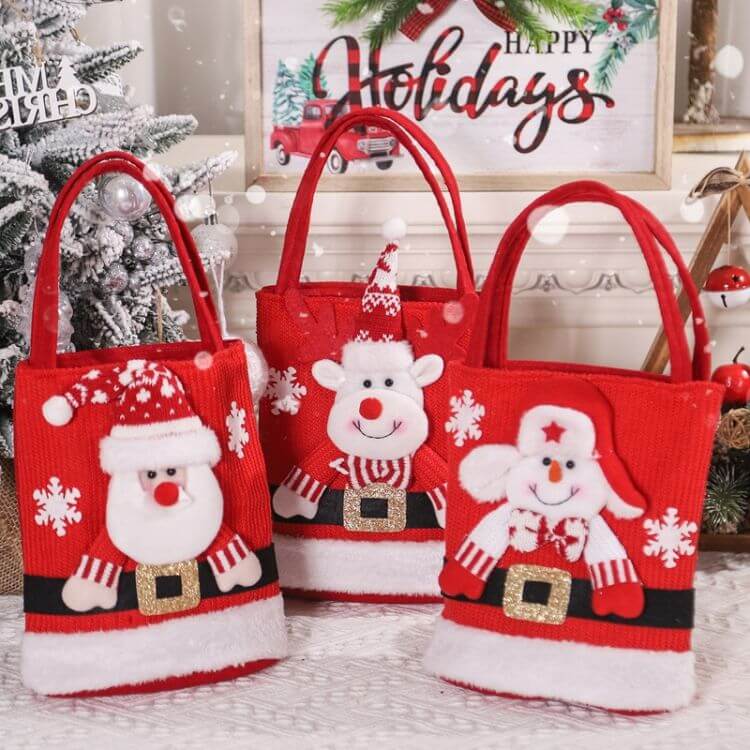 Christmas Candy Tote Bag for Kids with Santa, snowman, bear, and elk designs, ideal for holiday treats and gifts. Festive decorations in background.