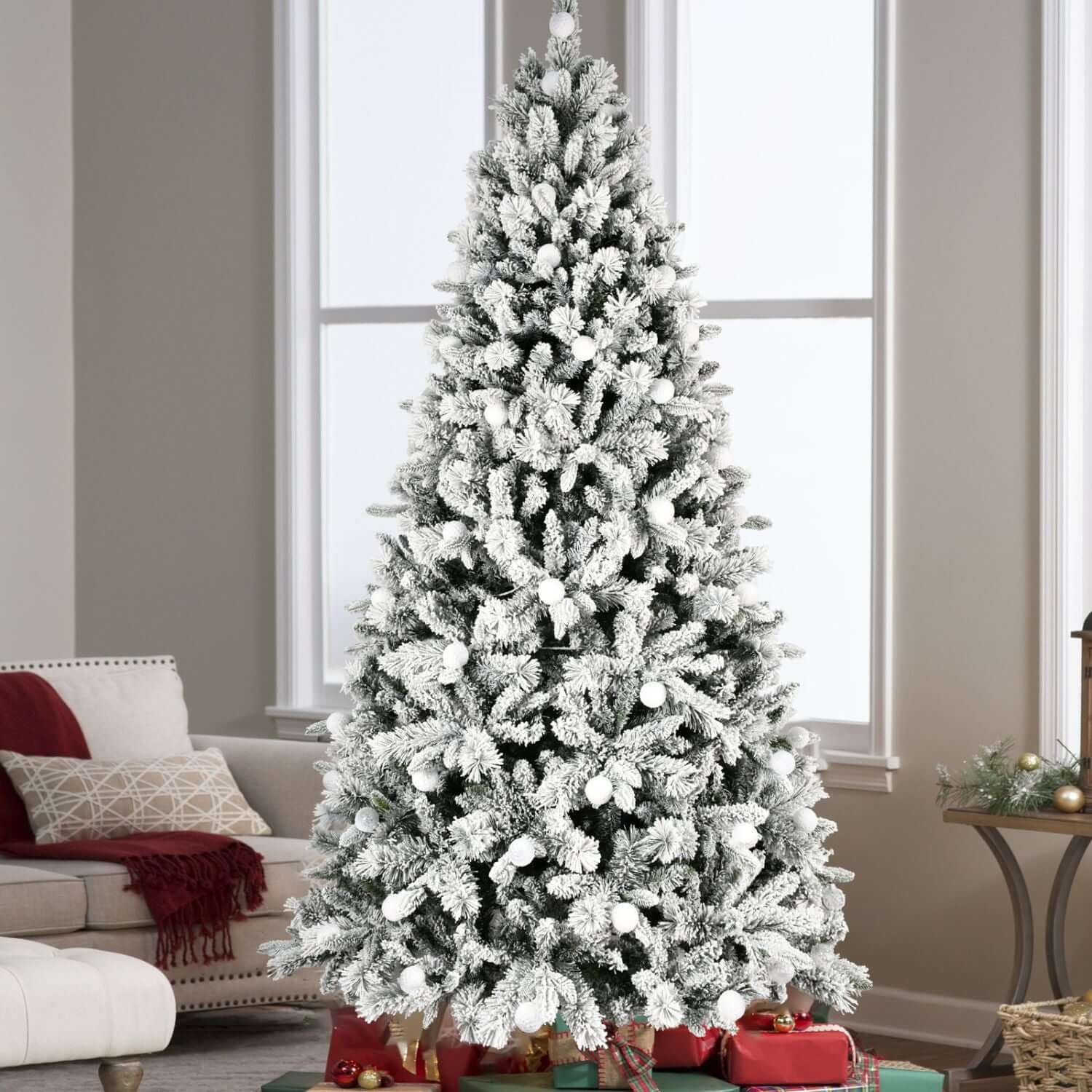 8ft Flocked Christmas Tree with Colorful Lights in a cozy living room, showcasing snowy branches and festive decor.