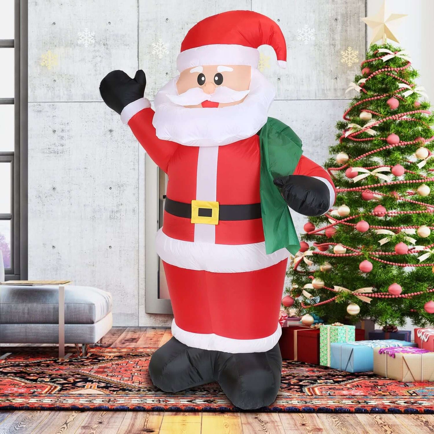 6.4ft Inflatable Christmas Giant Santa Claus with gift bag next to decorated tree indoors.
