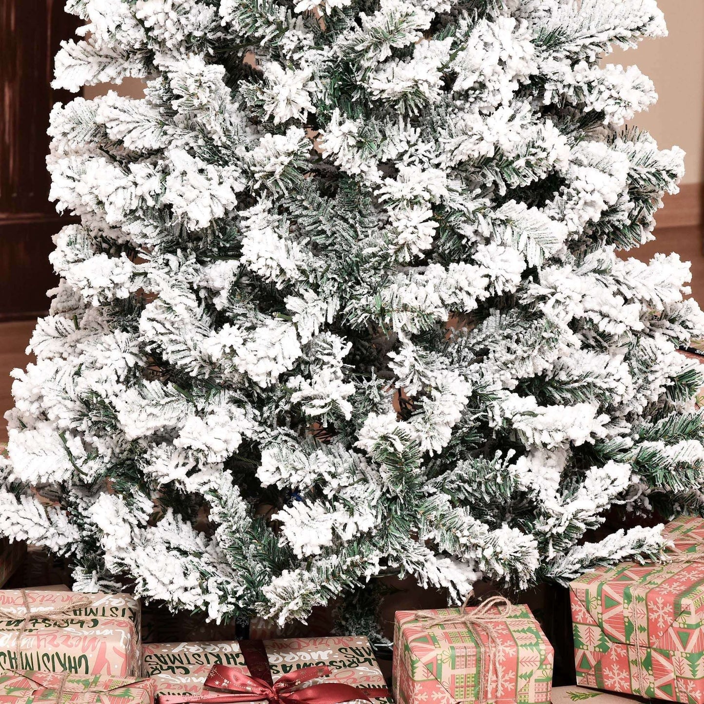 Pre-Lit Snow-Flocked Slim Douglas Fir Tree 7.5ft with gifts beneath, showcasing realistic snow-dusted branches indoors.