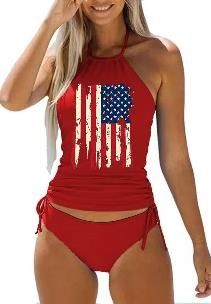 Red two-piece swimsuit with American flag print, sleeveless tankini top with drawstring sides. Stylish swimwear by The Tabby Spot.