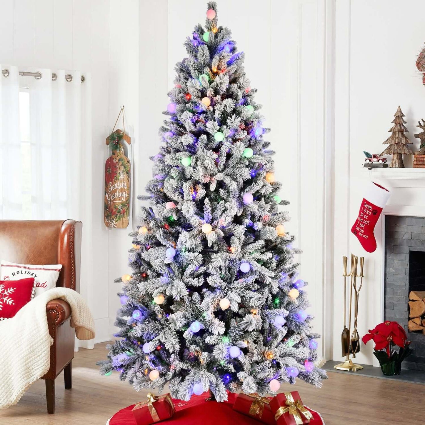 Flocked Christmas Tree with Colorful Lights in a cozy living room setting, showcasing snowy branches and vibrant LED colors.