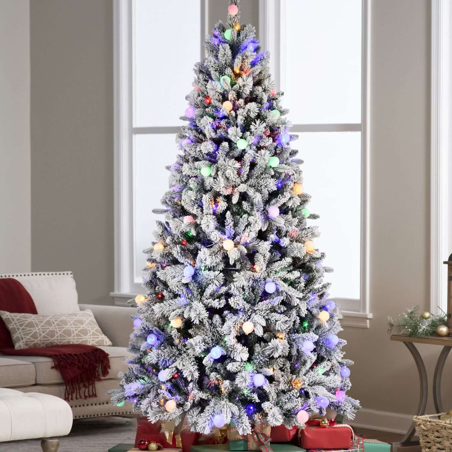 Flocked Christmas Tree with Colorful Lights in a cozy living room, featuring 8ft snow-flocked branches with 10 light modes.