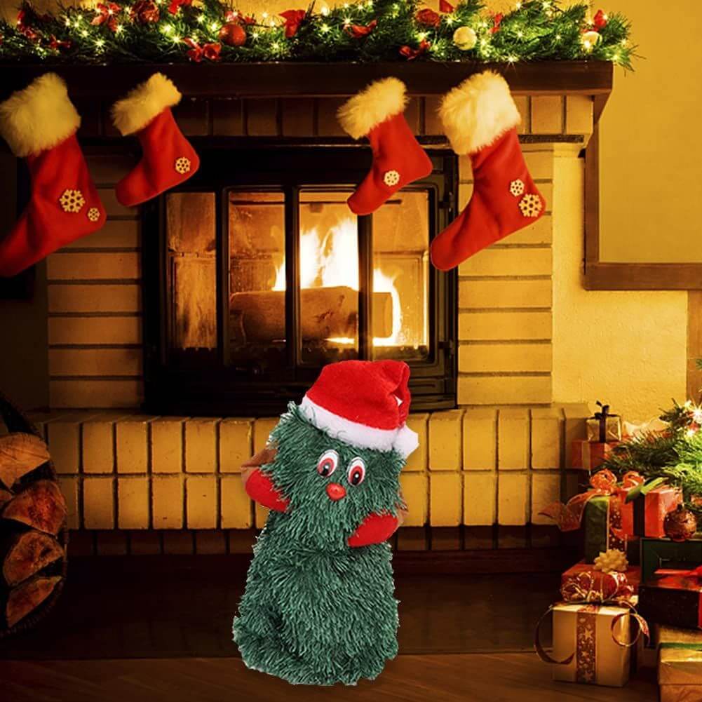 Electric Christmas Tree singing and dancing plush toy by the fireplace, surrounded by Christmas decorations and gifts.