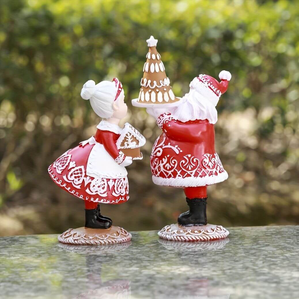 Small Ornament Couples Gifts Christmas Crafts featuring festive resin figures in red attire holding gingerbread cookies on a table.