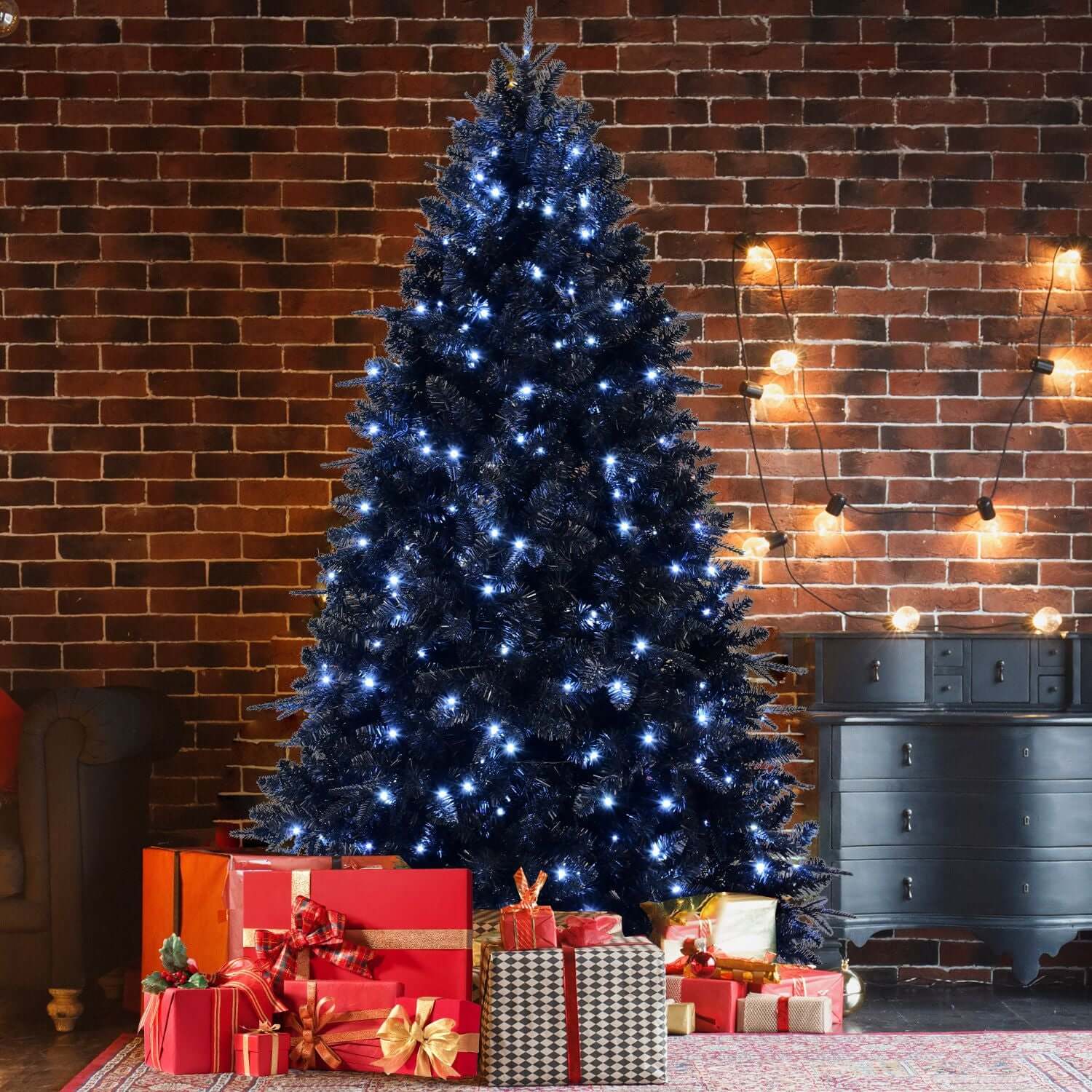 Black Christmas Tree with White LED Lights, 5ft holiday decor against a brick wall background, surrounded by wrapped gifts
