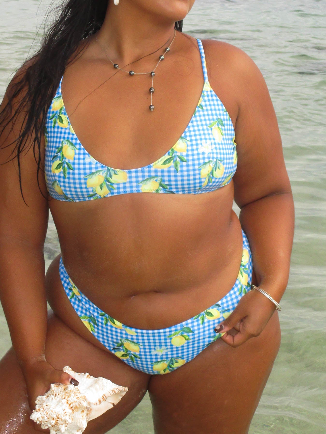 cece top - amalfi bralette style with blue gingham and lemon design on model by the water